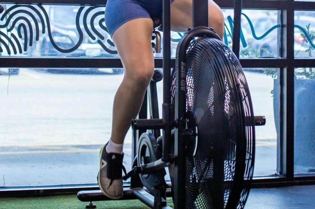 Woman Riding Stationary Bike During Exercise Leg Workout